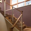 Custom built walnut stair case with wire railing 